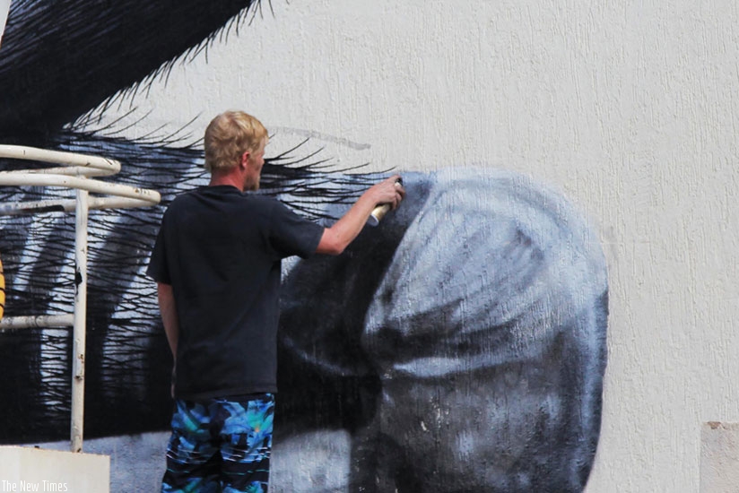 Street artist Roa painting an okapi.rnrn