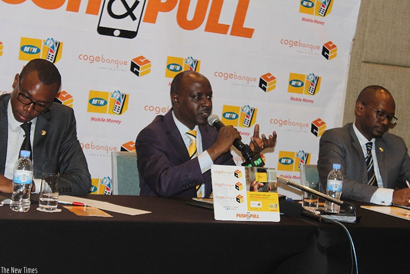 Munyampundu (centre) speaks after signing the partnership deal  as Mujyambere (left) and another official listen. / Peterson Tumwebaze.