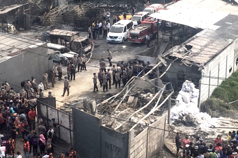 Indonesian forensic policemen work after a fire disaster in Tangerang Kota, Banten province. Net photo.