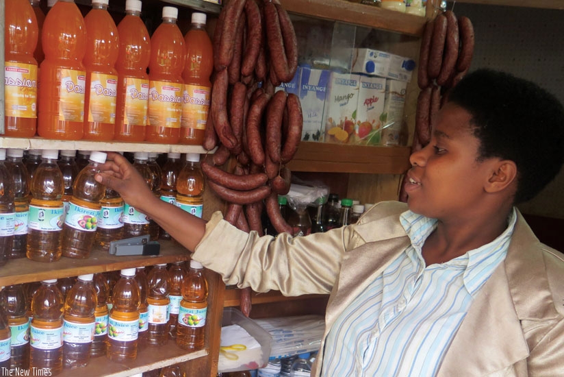 A trader arranges commodities in a shop in Kigali. File. 