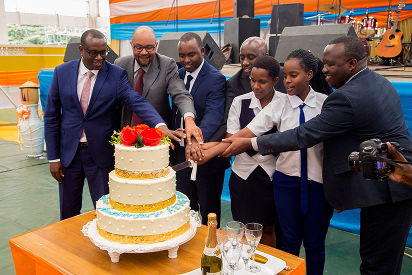 Local Government minister Francis Kaboneka joins other officials and some Association of Genocide Survivor Students (AERG) members to cut the cake as the young survivors marked the....