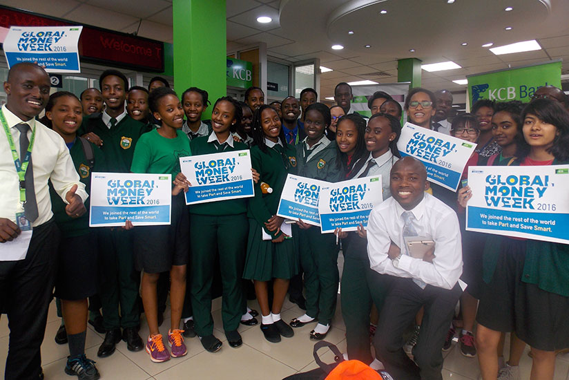 Green Hills students pose for a picture with KCB Bank staff during a study tour at one of the bank's branches as part of activities to mark last year's Global Money Week. 