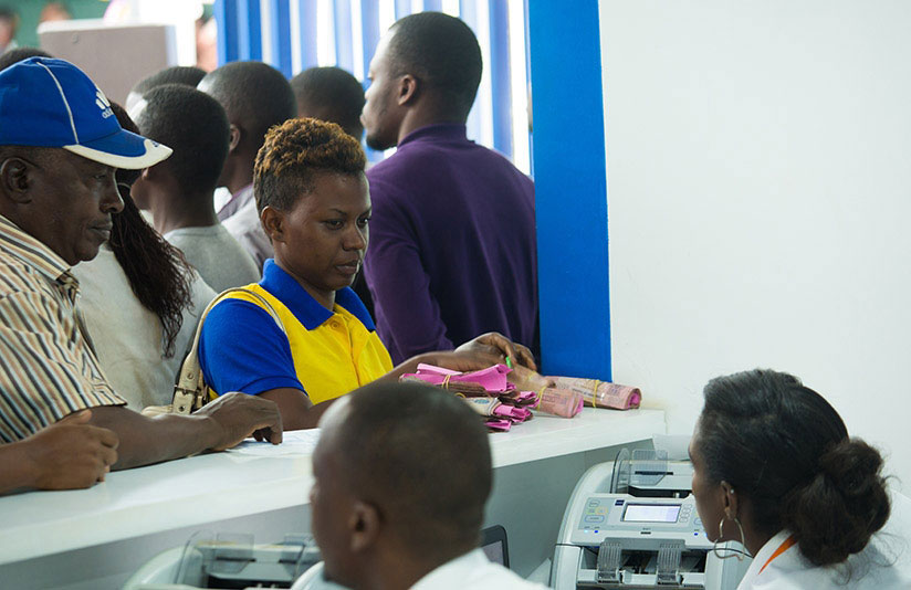 Customers deposit money at Bank of Kigali booth during the last Rwanda International Trade Fair. Rwanda seeks to increase national savings to 20% of GDP. / Courtesy