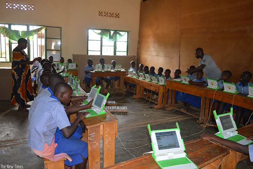 Pupils using OX laptops in Rushubi primary school.