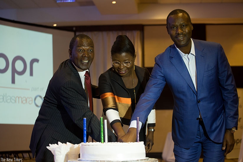 Prof Ndungu (left) cuts a cake with BPR clients at the event.  (All photos by Timothy Kisambira)