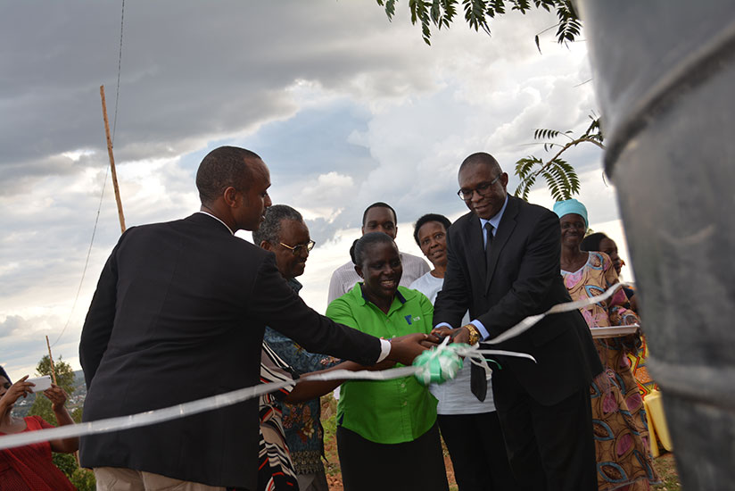 Odhiambo (right) is joined by local leaders to commission the water reservoirs at Ntarama Anglican Church of Rwanda Doicese on Friday. / Frederic Byumvuhore
