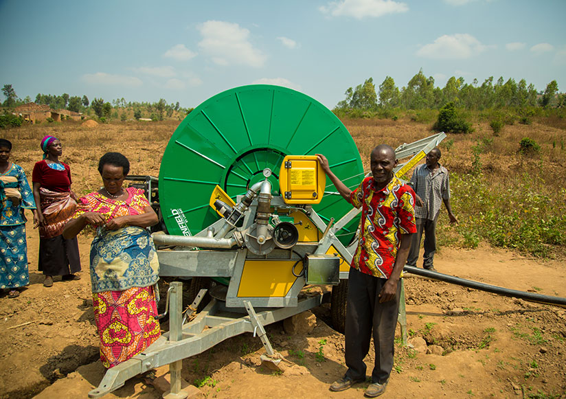 Farmers stand next to an irrigation water pump. Many SMEs don't access loans to expand their ventures. / File