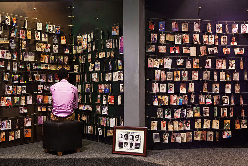 A man looks at the photos of some of the 1994 Genocide victims at Kigali Genocide Memorial. / File
