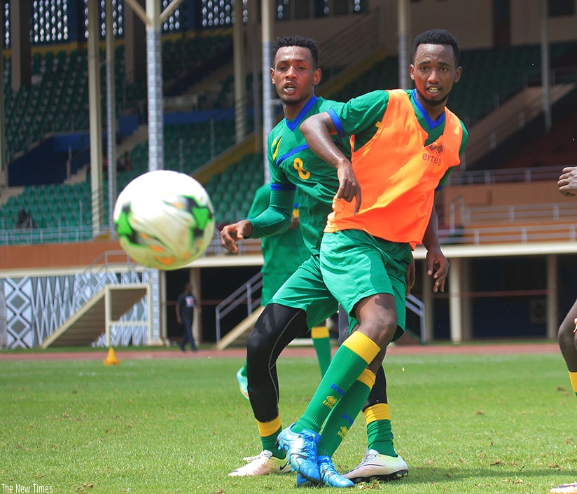 Amavubi striker Justin Mico and midifielder Ally Niyonzima in action during the training session last week at Amahoro Stadium. (Sam Ngendahimana)