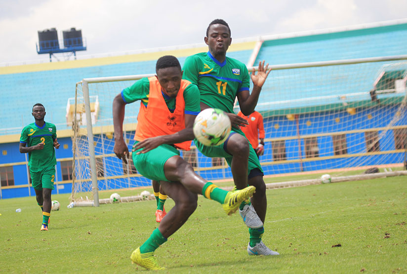 Hakizimana, right, tackles his APR teammate Djihad Bizimana during Amavubi training. Bizimana will miss the second leg due to suspension. rn/ Sam Ngendahimana