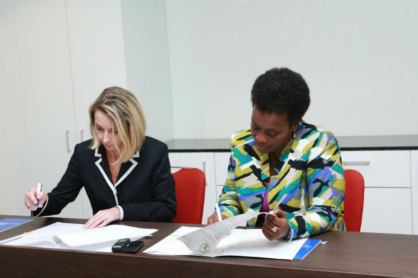 Jennifer Dent, the president of BVGH, and Dr. Gashumba sign the MoU on Thursday.