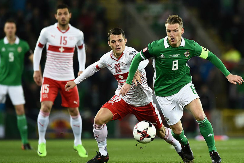 Northern Ireland captain Steven Davis - making his 100th international appearance - shields the ball from Granit Xhaka. / Internet photo
