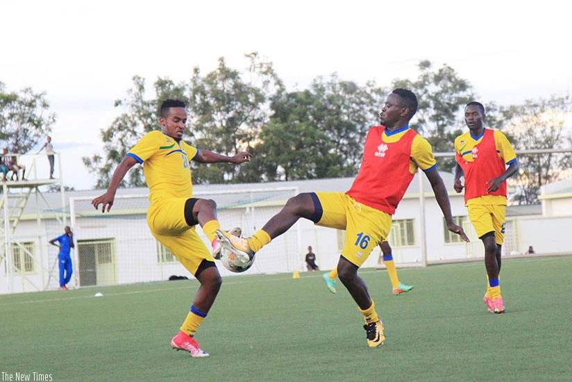Amavubi midfielders Yannick Mukunzi (L) and Muhadjir Hakizimana vie for the ball during training  at Kigali Stadium on Wednesday. S Ngendahimana.