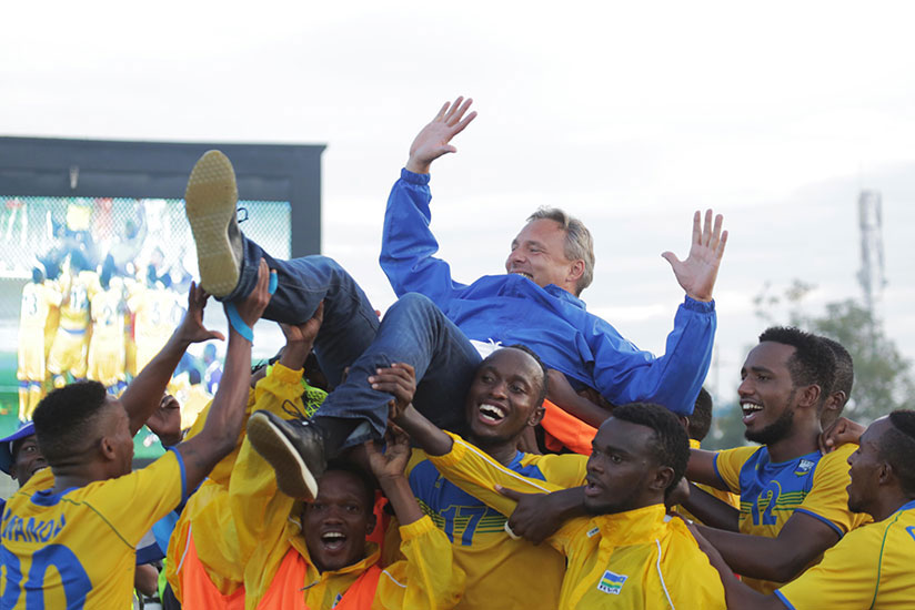 Amavubi players lift head coach Antoine Hey after drawing 0-0 with Ethiopia on Sunday at Kigali Stadium to qualify for CHAN 2018 Morocco. / Sam Ngendahimana