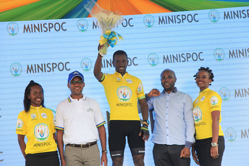 FERWACY boss Aimable Bayingana (2nd left) poses with the winner of stage one, Joseph Areruya on Monday. 
