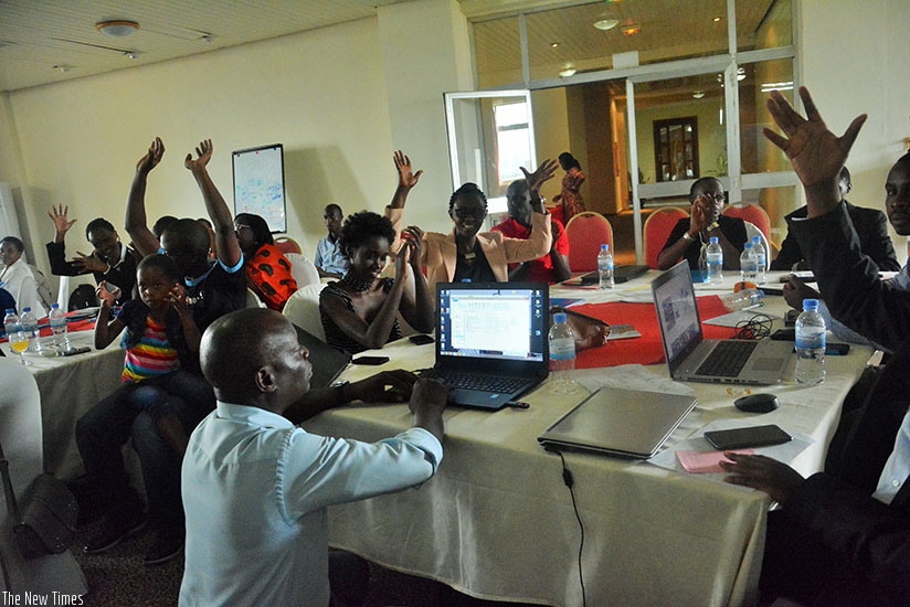 Participants make a hand of applause using sign language. / Diane Mushimiyimanarn