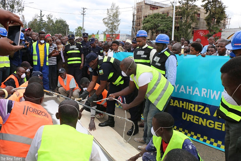 IGP Gasana paints a zebra-crossing at the launch of the road safety drive in Musanze District yesterday. Courtesy.