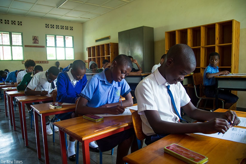 Candidates at Saint Ignace Primary School go through the examination papers on Monday. / Timothy Kisambira.