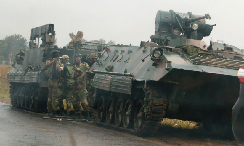 Soldiers stand beside military vehicles just outside Harare. / Internet photo