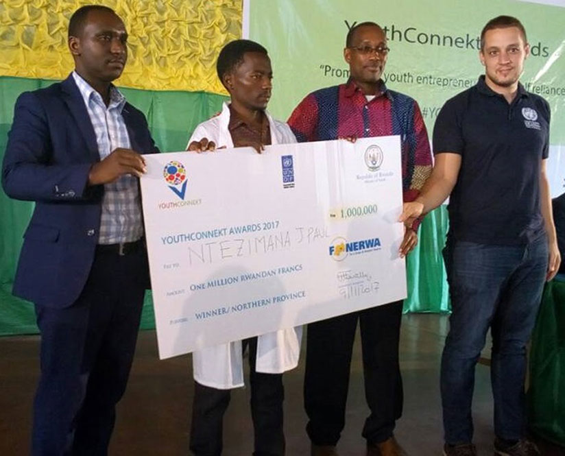 Furaha (left) is joined by other officials to hand over the prize money dummy cheque to Ntezimana after the competition in Musanze last week. (Photos by Michel Nkurunziza)