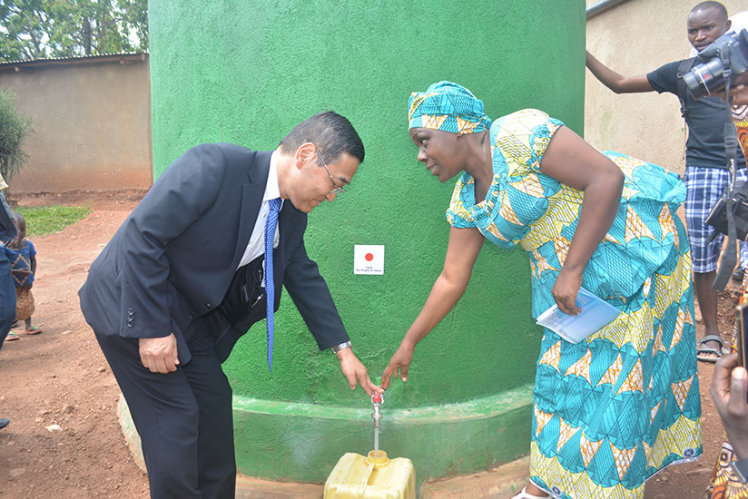 Takayuki Miyashita, the Japanese Ambassador to Rwanda together with Priscilla Uwiragiye, the Bugesera District vice-mayor in charge of social affairs fetching water from a new wate....