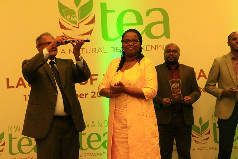 Mukeshimana (middle) poses for a photo with some representatives of the factories that won. / Peterson Tumwebaze