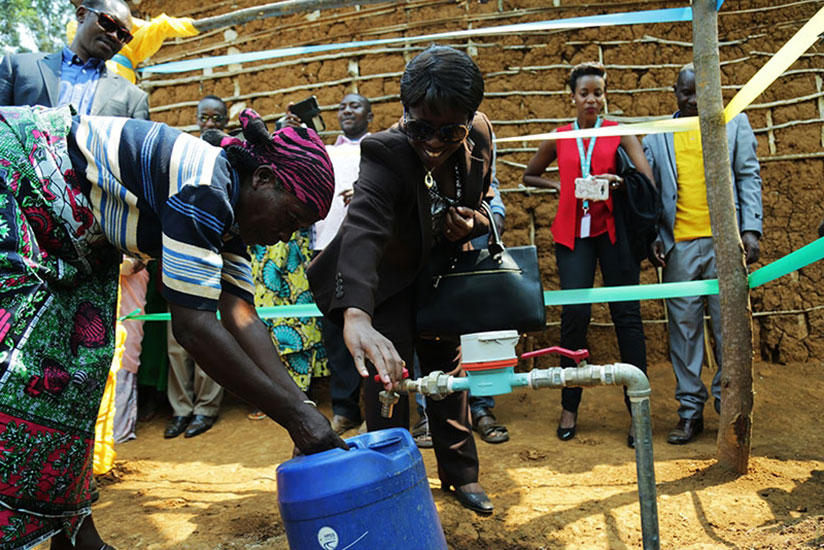 Minister Kamayirese (middle) launches a new water project in Nkombo Island in Rusizi District recently. / Timothy Kisambira