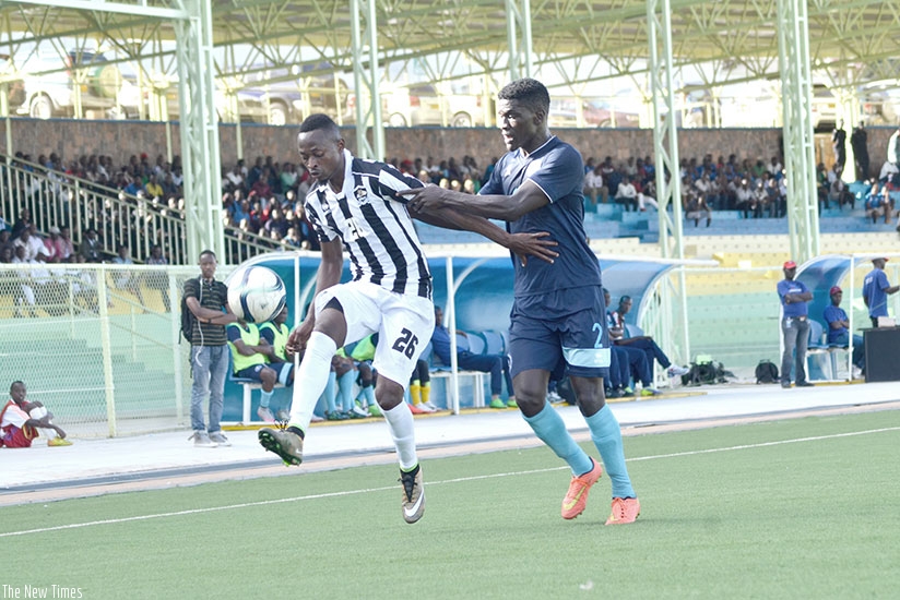 APR forward Issa Bigirimana controls the ball under pressure from Police defender Hussein Habimana during a league match between the two teams last season. (S. Ngendahimana)