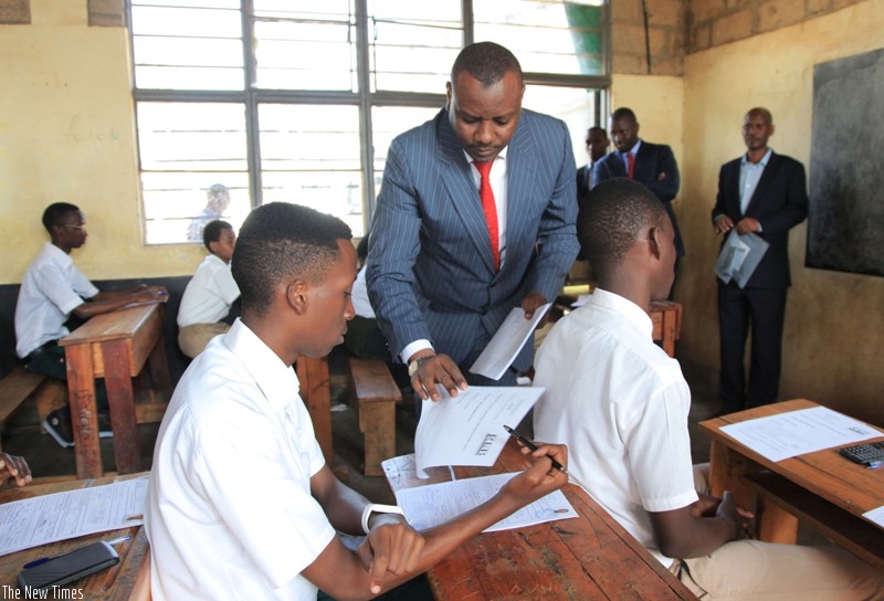 Munyakazi distributes examination papers at GS Remera examination centre in Kigali Tuesday morning.  Sam Ngendahimana. 