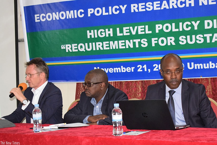 Dr Hermann Boemel, the GIZ programme manager, speaks at the policy dialogue on Tuesday. Rugwabiza (centre) and Prof Ndahirirwe listen to the presentation. (Lydia Atieno)