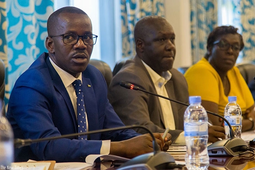 Uwizeyimana (L) explains the amendments to MPs on the committee last week. (File). rn