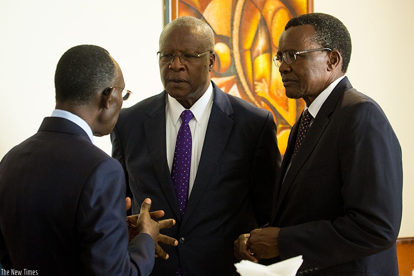 Chief Justice Sam Rugege (with back to camera) chats with his counterparts Bart Katureebe (C), of Uganda, and David Kenani Maraga, of Kenya, in Kigali yesterday. (Photos by Timothy Kisambira)