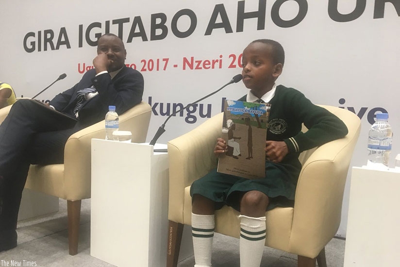 Cyusa, the author of a story book, Ntibavuga Bavuga, on the panel discussion with Minister Isaac Munyakazi. / Diane Mushimiyimana.