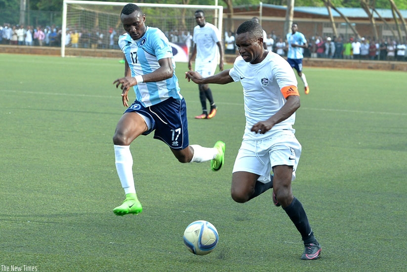 Police FC midfielder Amini Mwizerwa closes in on APR FC captain Albert Ngabo on Wednesday. / Sam Ngendahimana