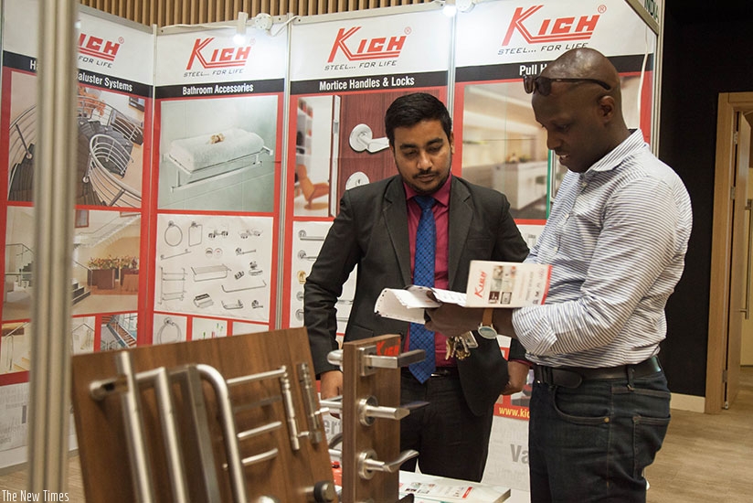 An exhibitor explains his products to visitors during BuildExpo. / Nadege Imbabazi