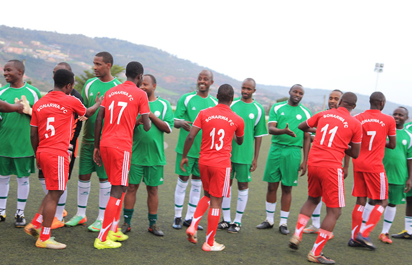 BNR FC and SONARWA FC players shake hands before the match. 