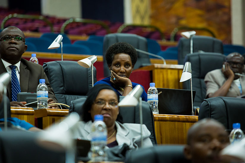 Lawmakers follow a video presentation on radiation elements at Parliament. / Timothy Kisambira