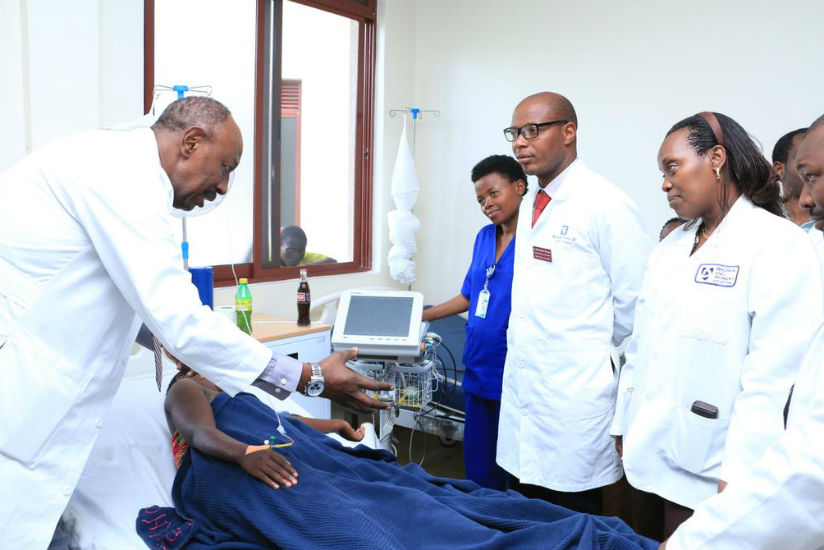 Dr. Nyirinkwaya (L) explains to the medics at Shyira how to treat an expectant mother as Dr. Gashumba looks on.