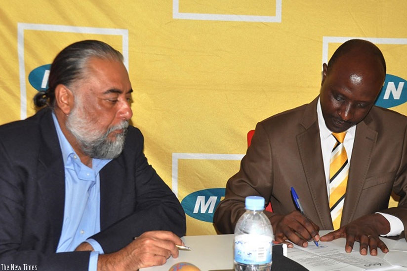 Singh and Munyampundu (right) sign the deal on Tuesday. The partnership supports government efforts, encouraging Rwandans to embrace electronic payment platforms and facilities/ Pe....