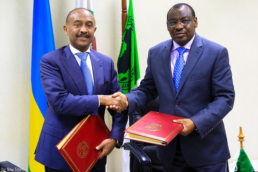 Director General for AfDB in EAC region Gabriel Negatu shakes hands with Minister Claver Gatete yesterday in Kigali. Faustin Niyigena