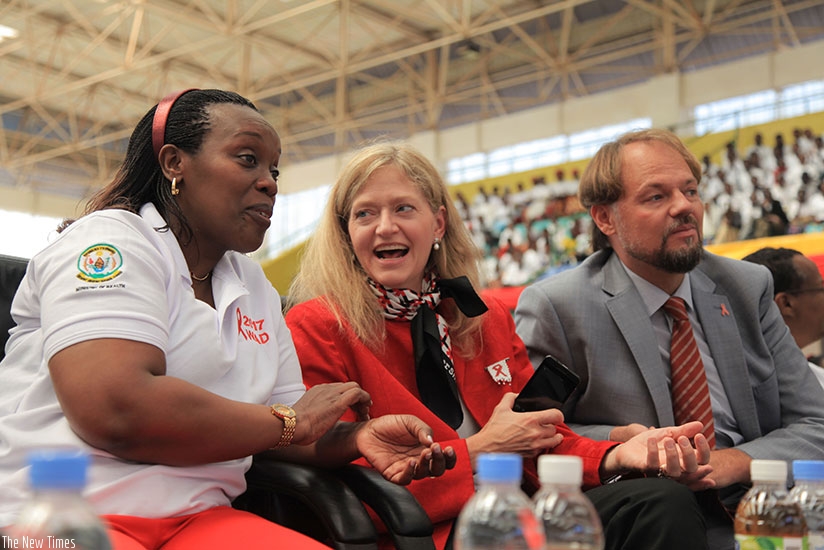 (L-R) Health minister Dr Diane Gashumba chats with US Ambassodor Erica Barks-Ruggles as UNFPA repesentative Mark Bryan looks on during the event to mark World AIDS Day at Amahoro N....