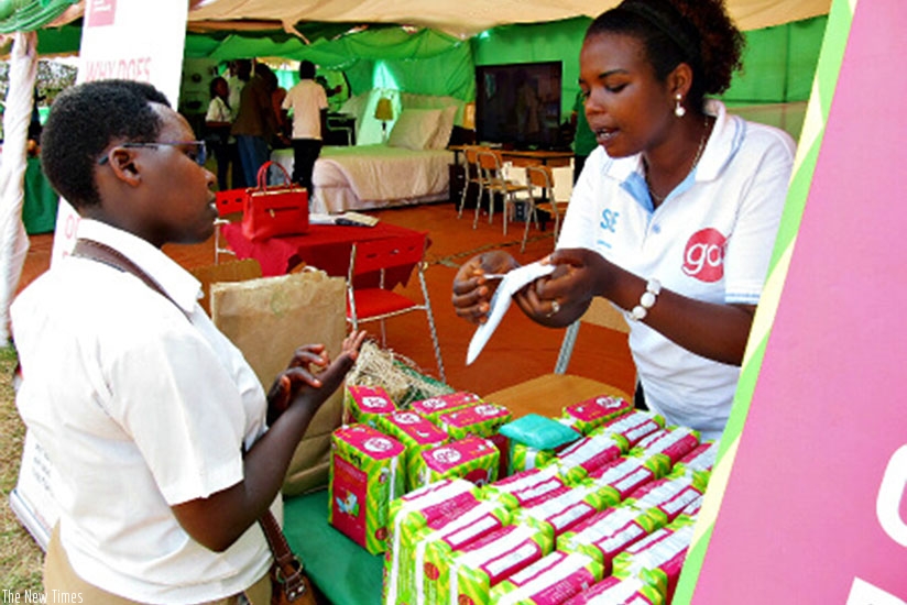 A sales person explains how their locally-made sanitary pads work during a past expo. File