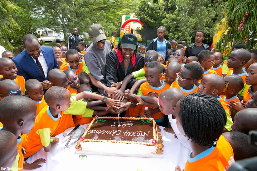 President Kagame and First Lady Jeannette Kagame joined children at the annual End of Year Childrenu2019s Party to cut the cake at Village Urugwiro yesterday. Courtesy.