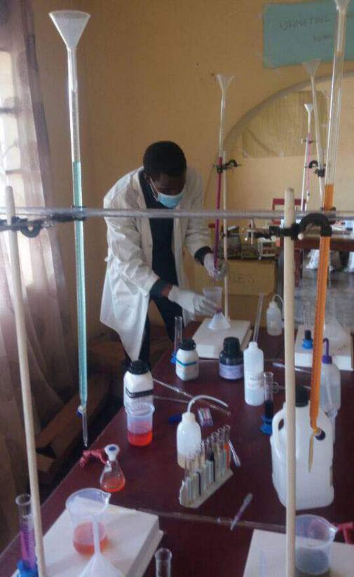 Masabo conducting an experiment at his laboratory in Kibungo. / Frederic Byumvuhore