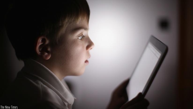 A ten-year-old boy uses an Apple iPad tablet computer on November 29, 2011 in the UK. Facebook is testing out technologies that would allow children 13 and under to use the site.