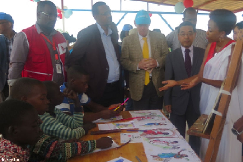 Ambassador Takayuki (2nd Right) and other officials inspect children painting art work at Mahama Refugee Camp during their visit last week. / Eddie Nsabimana. Ambassador Takayuki (2nd Right) and other officials inspect children painting art work at Mahama Refugee Camp during their visit last week. / Eddie Nsabimana.