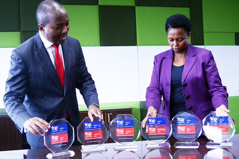 Mwangi ( left) and Pertet display the financial services sector 2017 Top Employer trophies at the firmu2019s head office in Nairobi. / Courtesy.