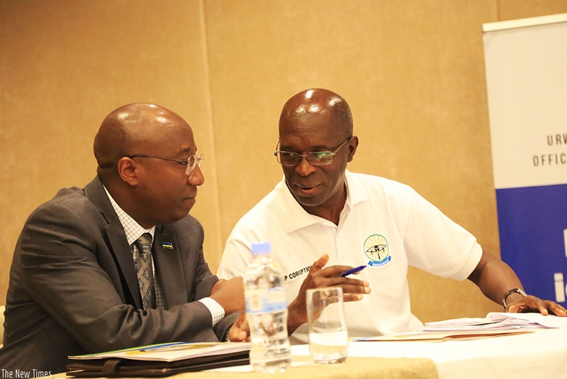 Prime Minister Edouard Ngirente (L) chats with Ombusman Anastase Murekezi during the event in Kigali. Sam Ngendahimana.