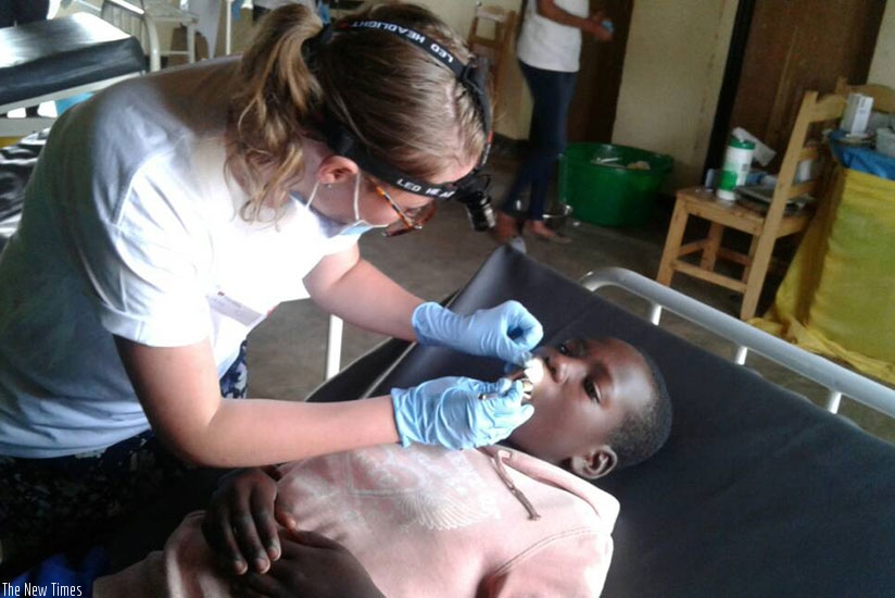 A dentist attends to a patient. Using protective gear while attending to patients prevents the spread of infections. / Lydia Atieno.
