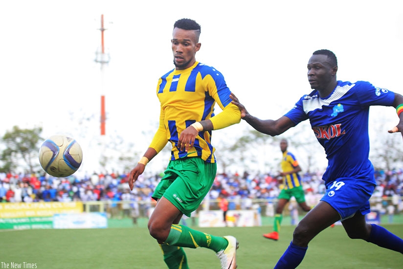 AS Kigali's midfielder  Ally Niyonzima vies for the ball with Rayon Sports striker Tidiane Kone during a past match this season. The league will resume on Dec. 19. Sam Ngendahimana.